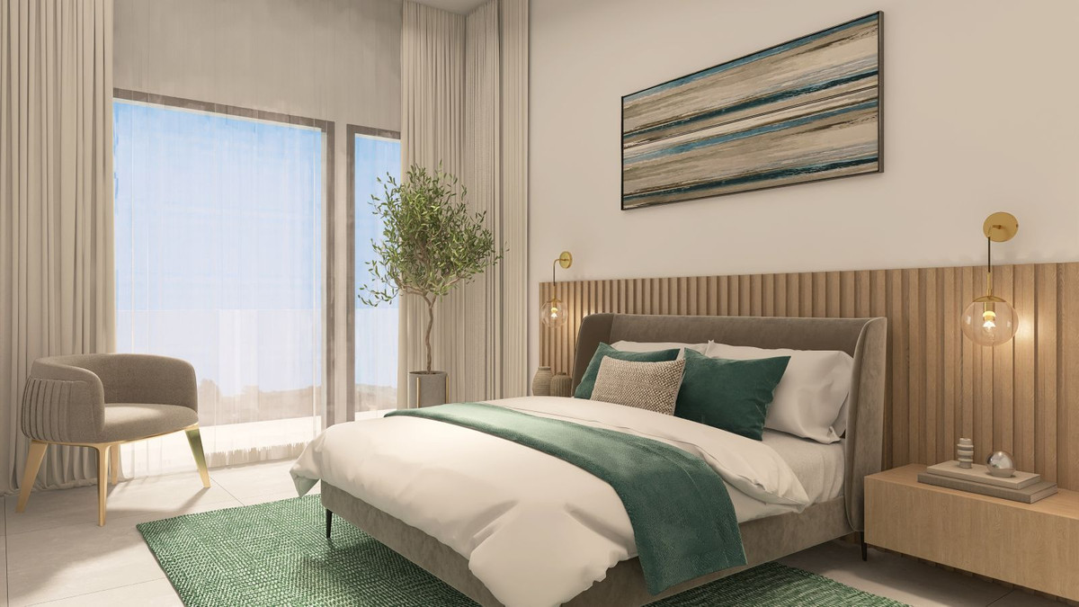 Moderne slaapkamer met groen accent en veel lichtinval.