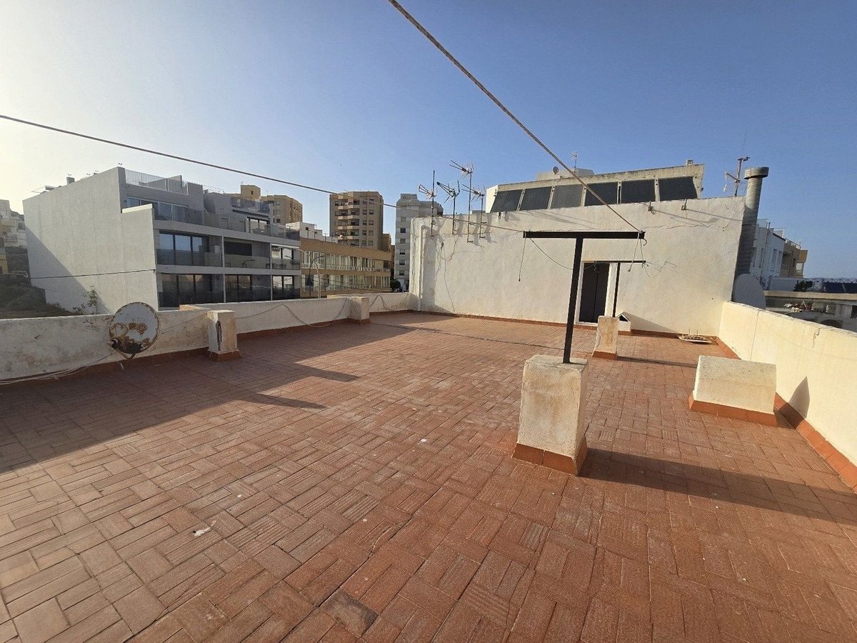 Rooftop terrace with brick flooring and city buildings view