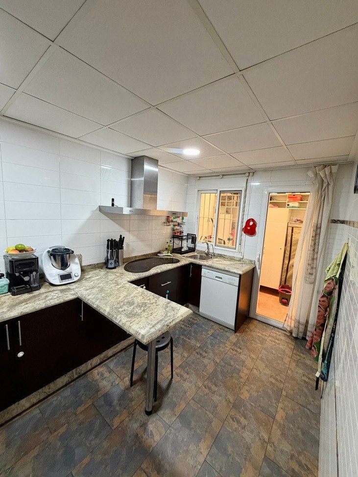 Modern kitchen with dark cabinets, granite countertops, stainless steel appliances, and a breakfast bar area.