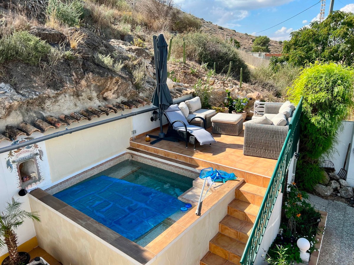 Outdoor patio with plunge pool, seating, and mountain view
