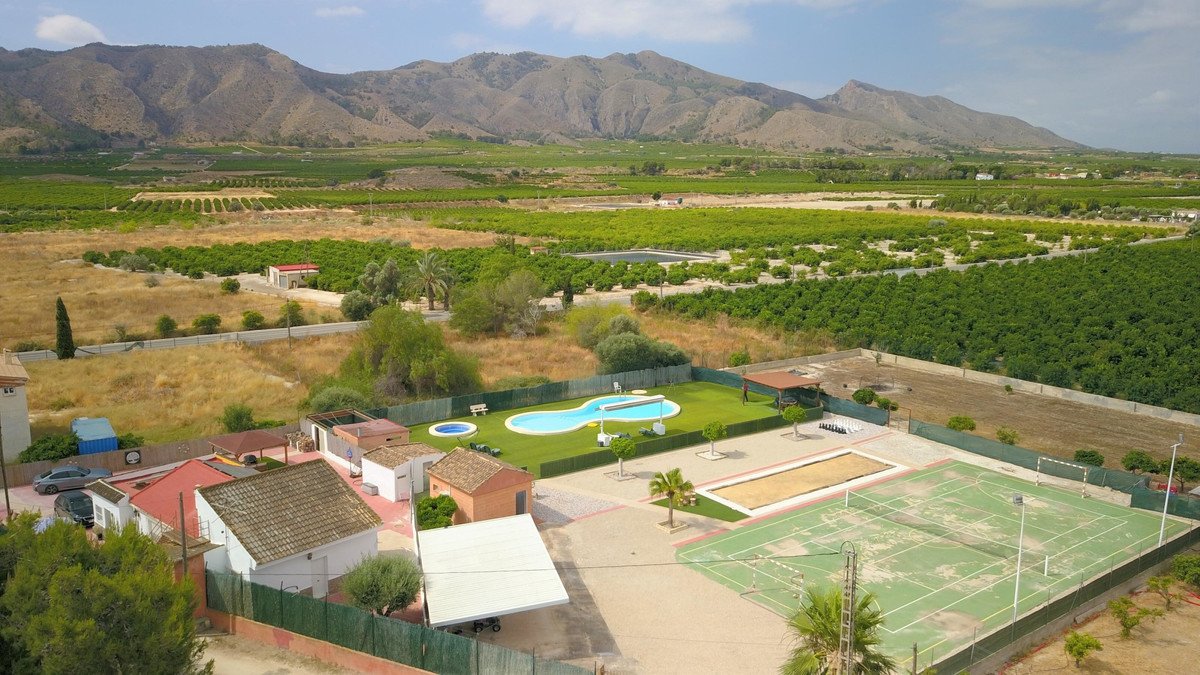 Spacious rural estate with a freeform swimming pool, tennis and basketball courts, bocce court, and distant mountain views.