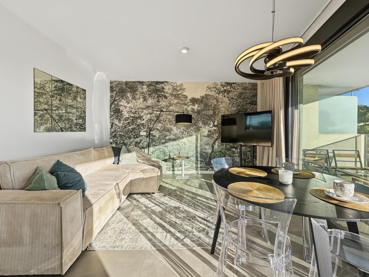 Modern living and dining area with open view to outdoor space