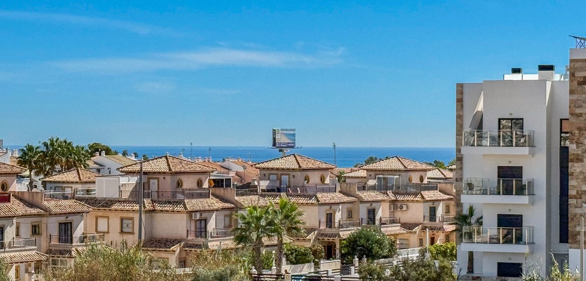 Apartment with sea view and terracotta roofs in coastal residential area