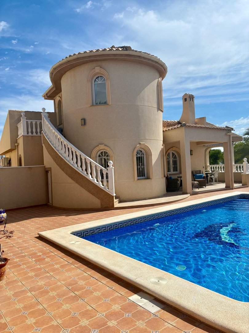 Villa with a swimming pool, outdoor terrace, and curved architectural design