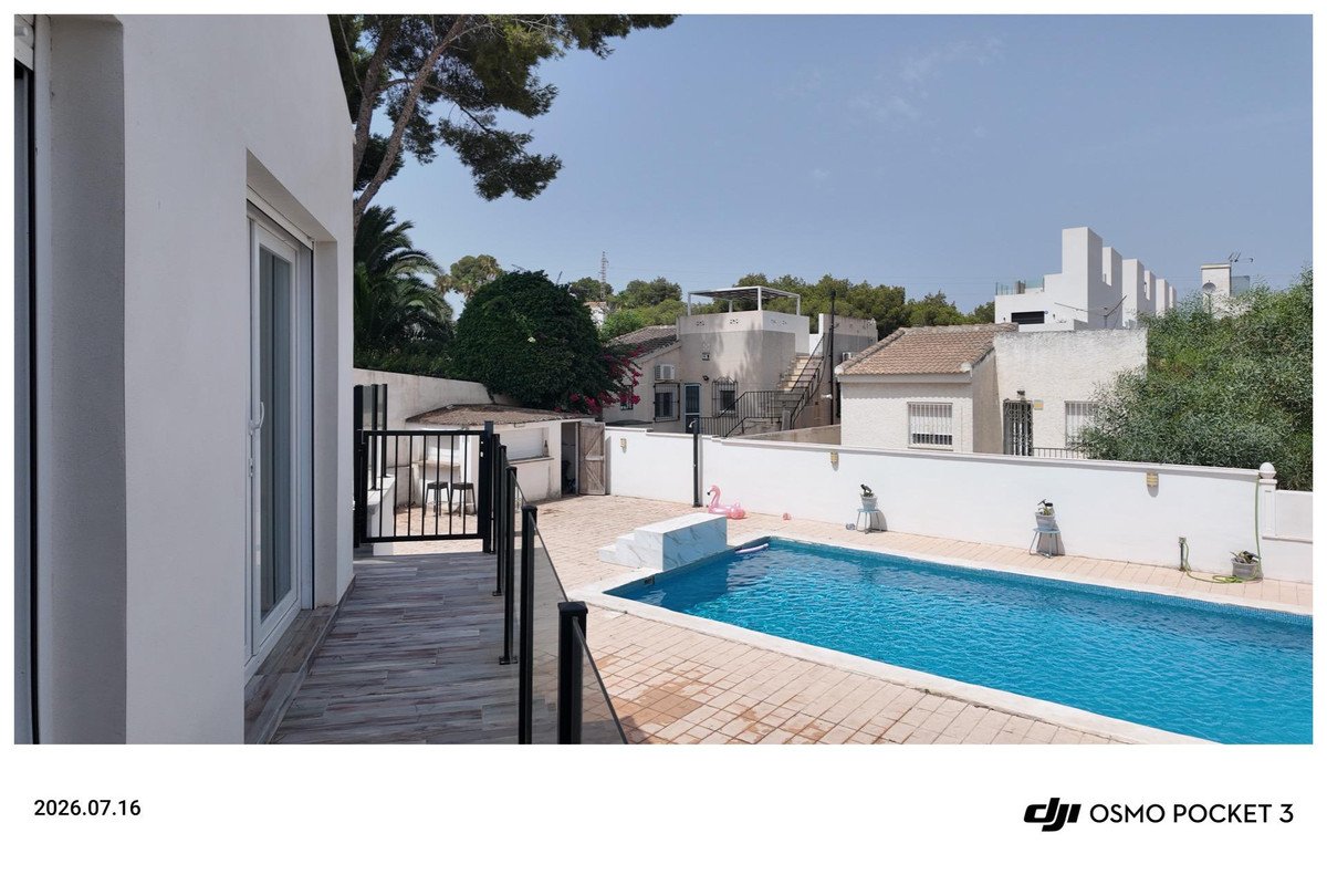 Patio with swimming pool, outdoor deck, and view of neighboring buildings