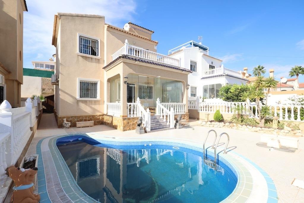 Two-story villa with a swimming pool and outdoor patio area