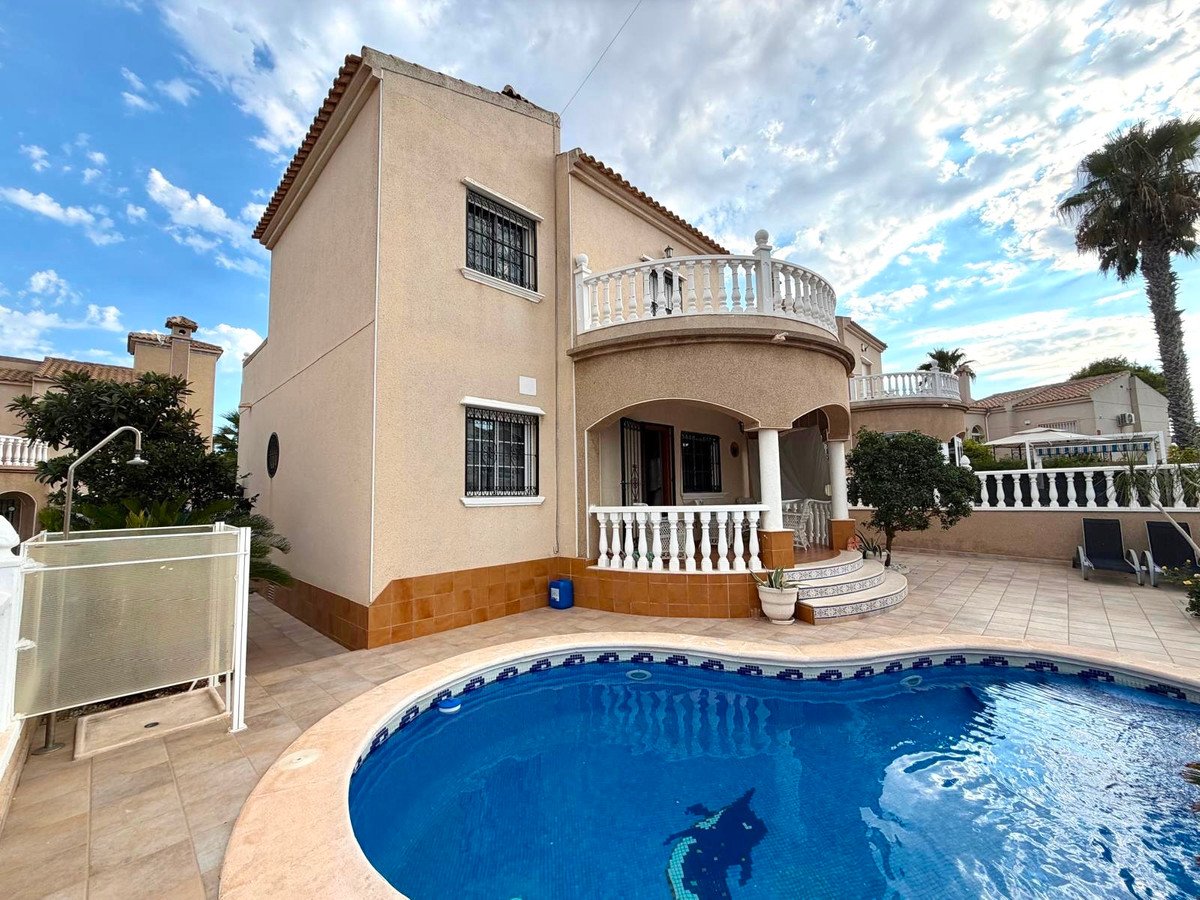 A villa with a private swimming pool, outdoor shower, and a balcony overlooking the patio.