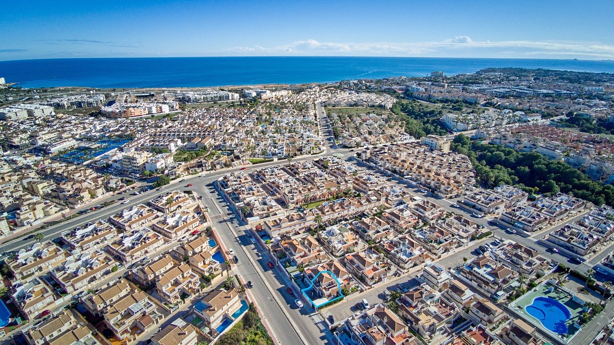 Aerial view of a coastal town with ocean and residential buildings