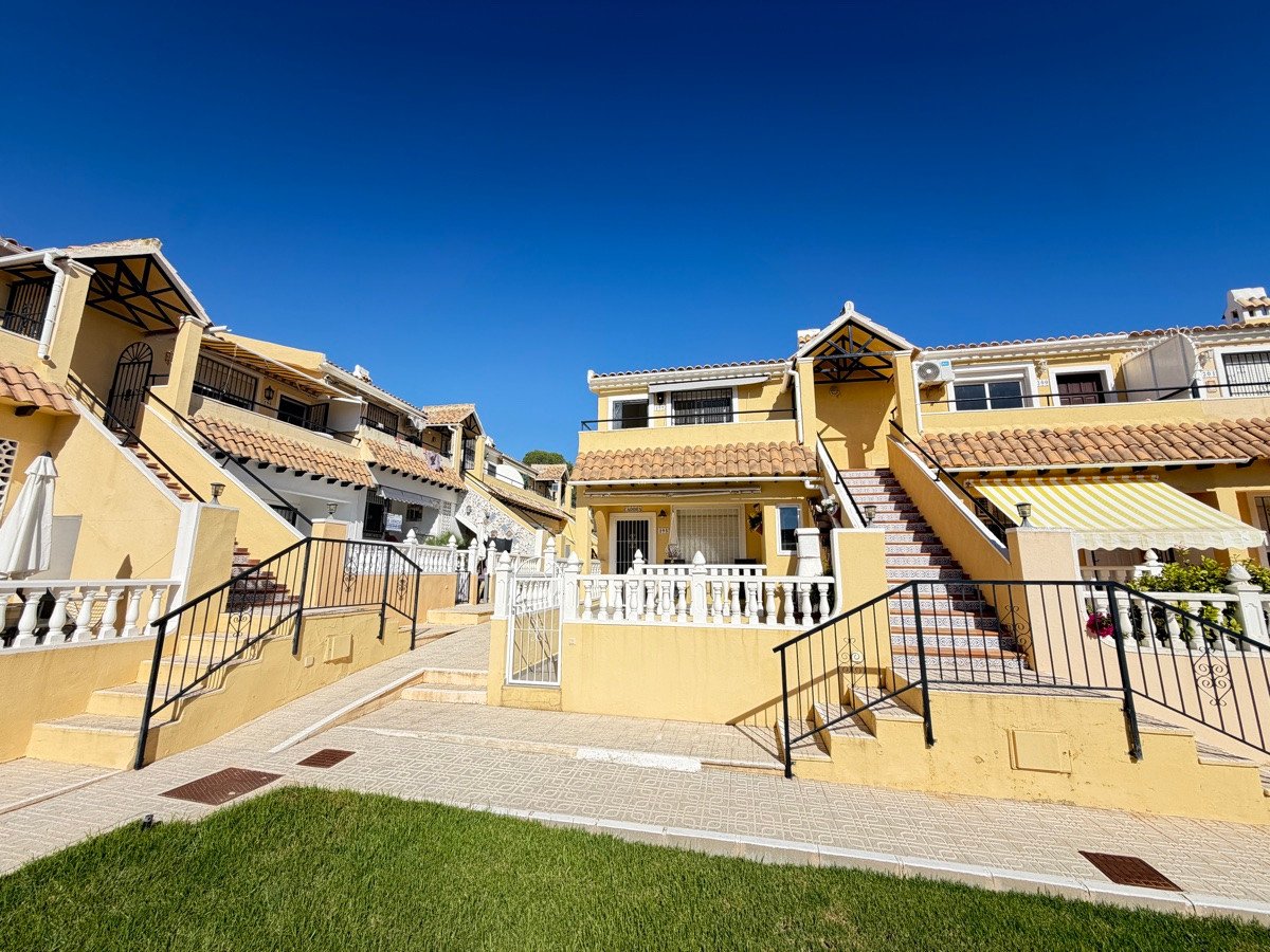 Yellow townhouses with stairs, terraces, and sunny outdoor space