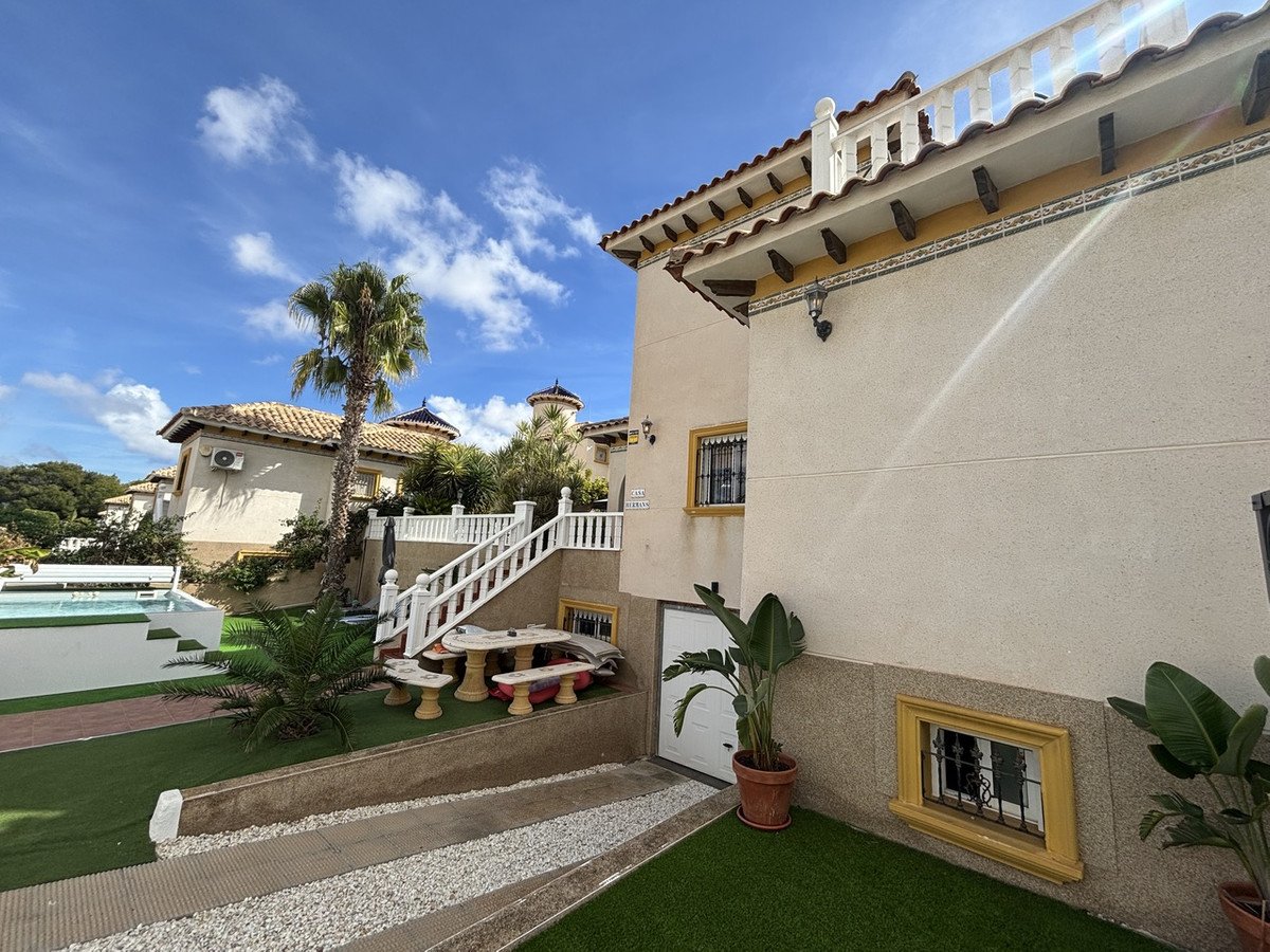 Villa patio with pool, palm tree, and outdoor seating area