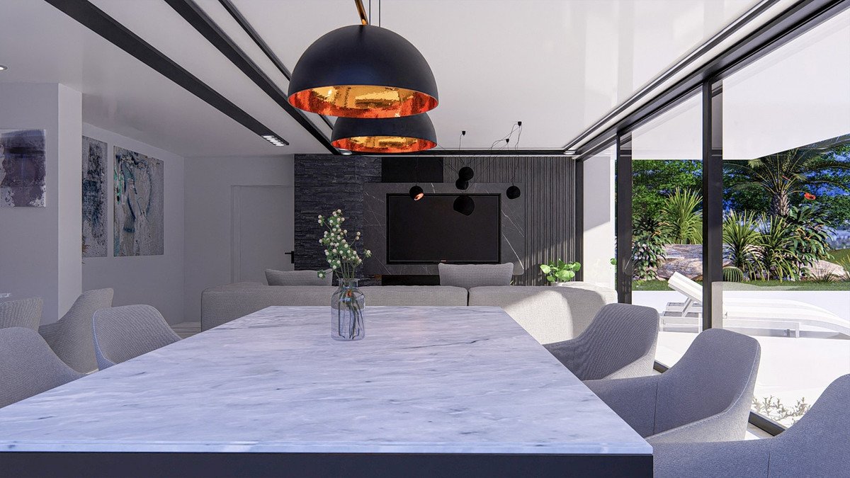 Modern living area with marble table, sofa, and large windows offering a view of a lush green garden and pool.