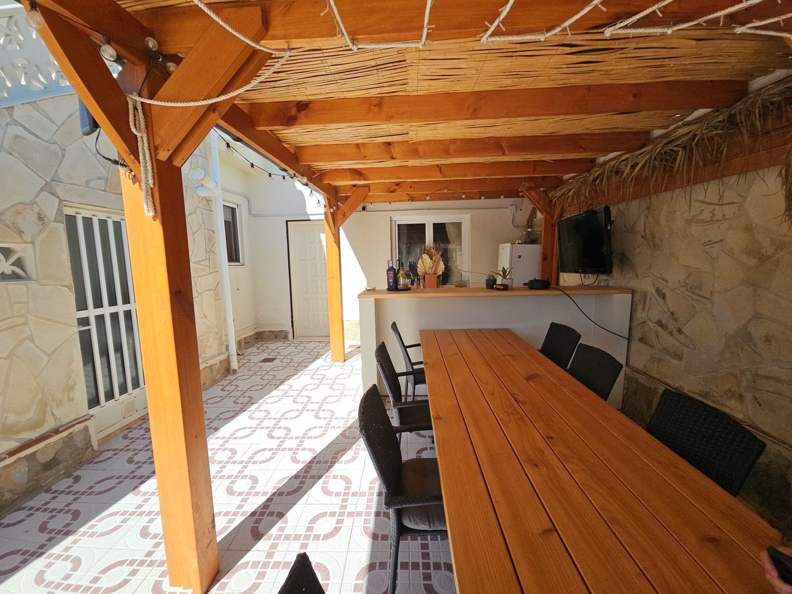 Overdekte patio met eethoek en houten tafel