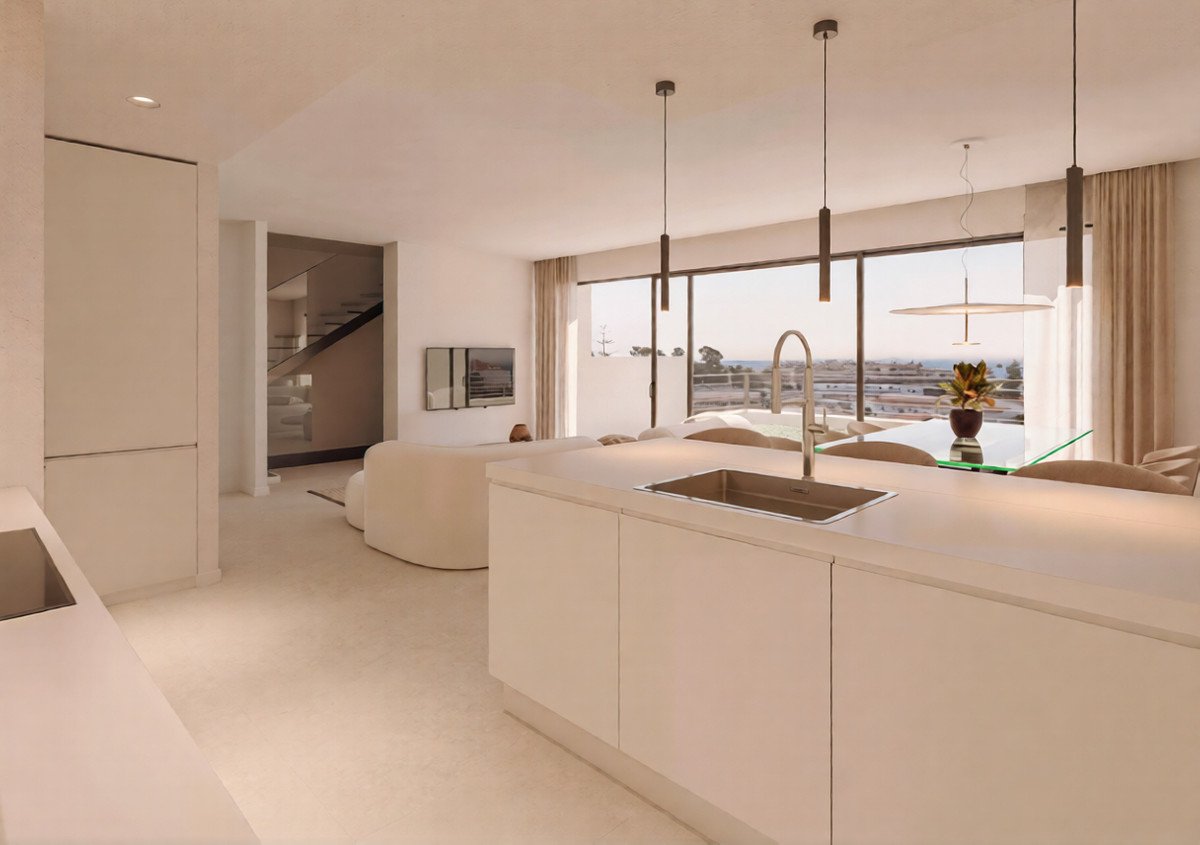 Modern open-plan kitchen and dining area with a large sink and a beautiful sea view through the window.