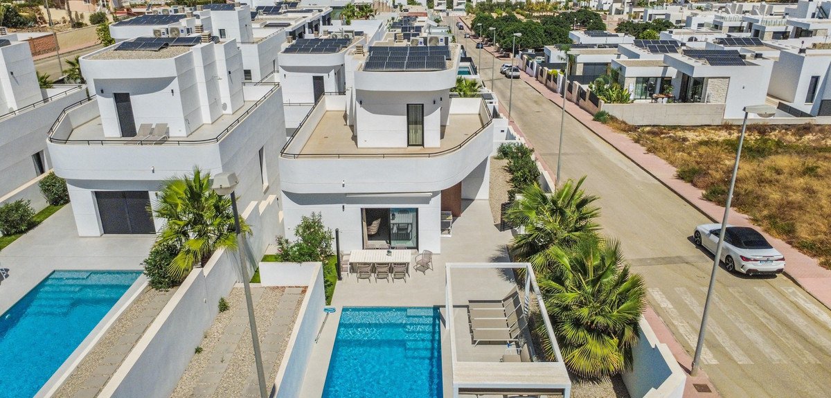 Aerial view of a modern villa with swimming pool and outdoor seating area