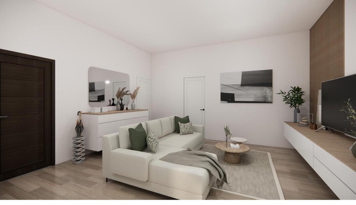 A modern, light-colored sectional sofa in a living room with minimalist decor, abstract art, and a television.