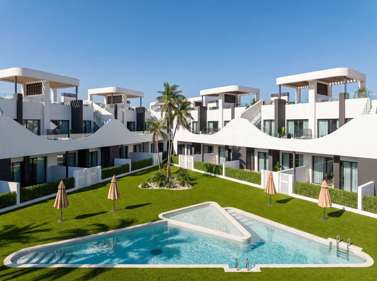 Modern apartments with a unique triangular pool, lush green lawn, palm trees, and a clear blue sky.