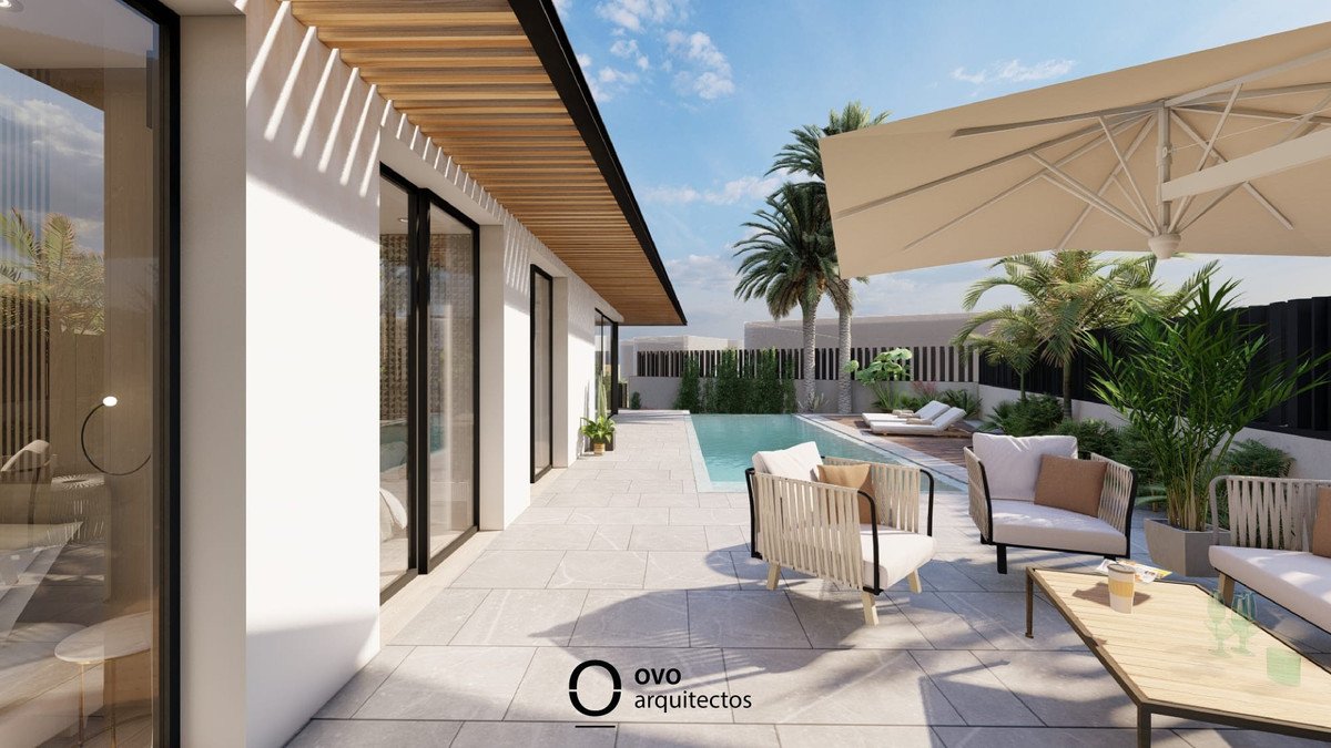 Modern patio with a swimming pool, comfortable outdoor seating, lounge chairs, and lush palm trees under a sunny sky.