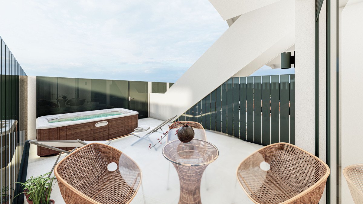 Modern terrace with a hot tub, lounge chairs, and a small table with chairs, offering an outdoor relaxation space.
