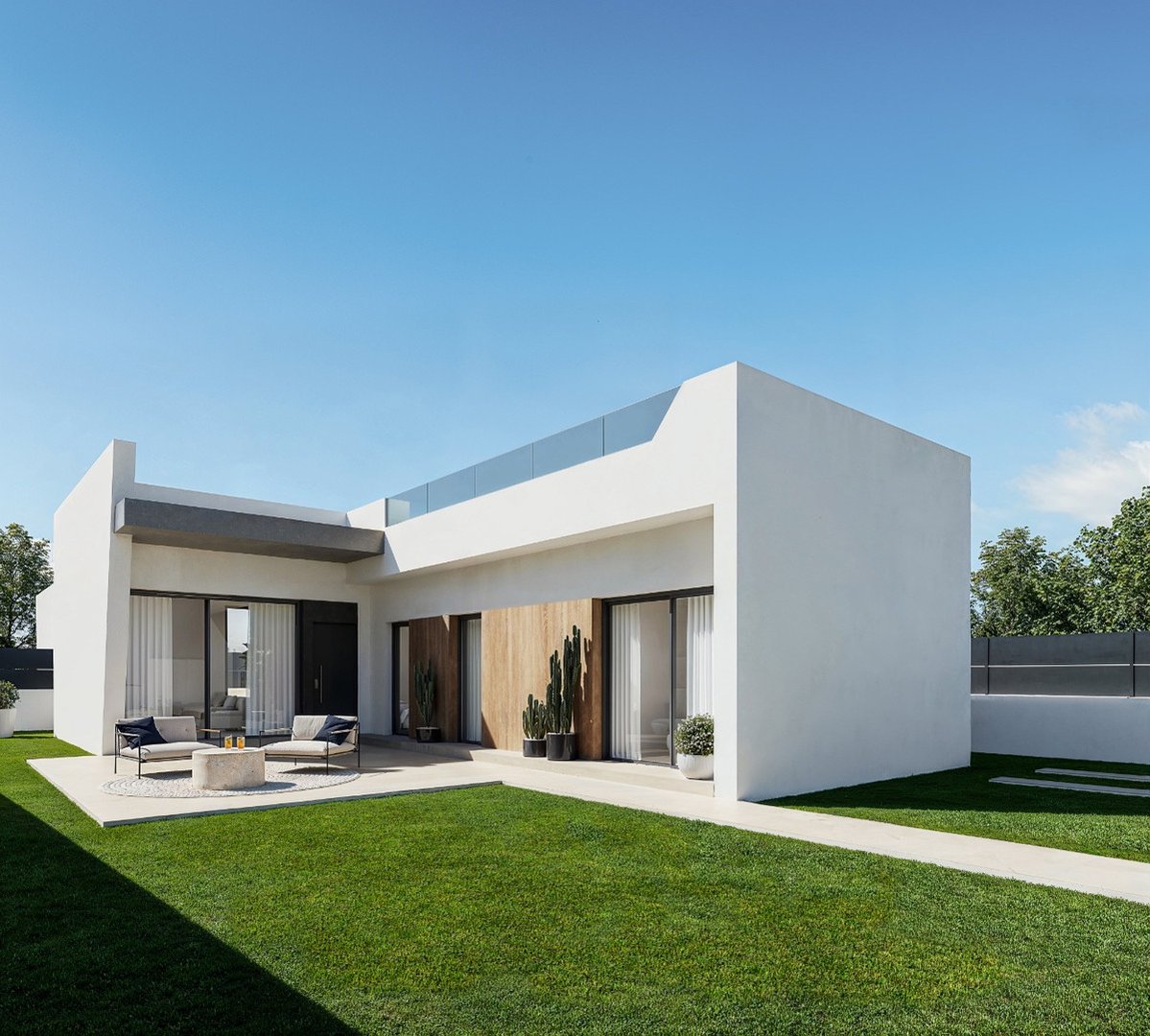 Modern villa exterior with a white facade, outdoor seating area on a patio, and a lush green lawn.