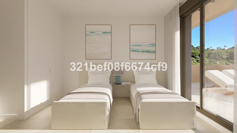 Minimalist twin bedroom with white beds, sea-themed artwork, and a balcony with lounge chairs overlooking a green landscape.