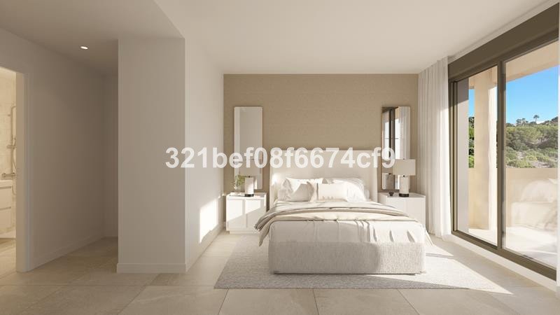 Modern bedroom with a large window overlooking a balcony and a lush green hillside view.