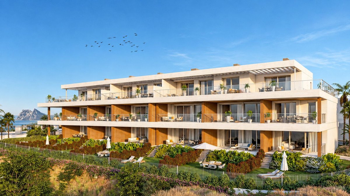 Modern three-story apartment complex with sea view and landscaped gardens