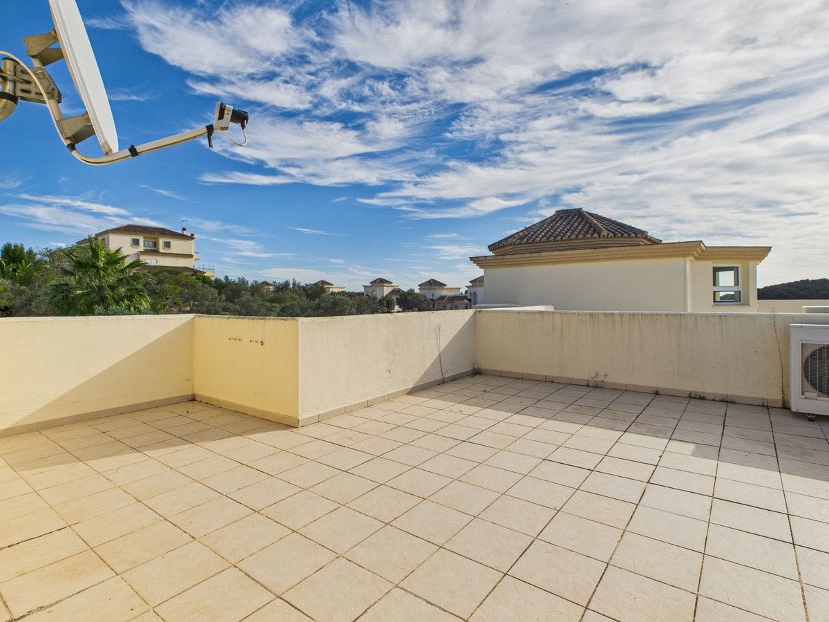Sunny rooftop terrace with satellite dish and scenic view
