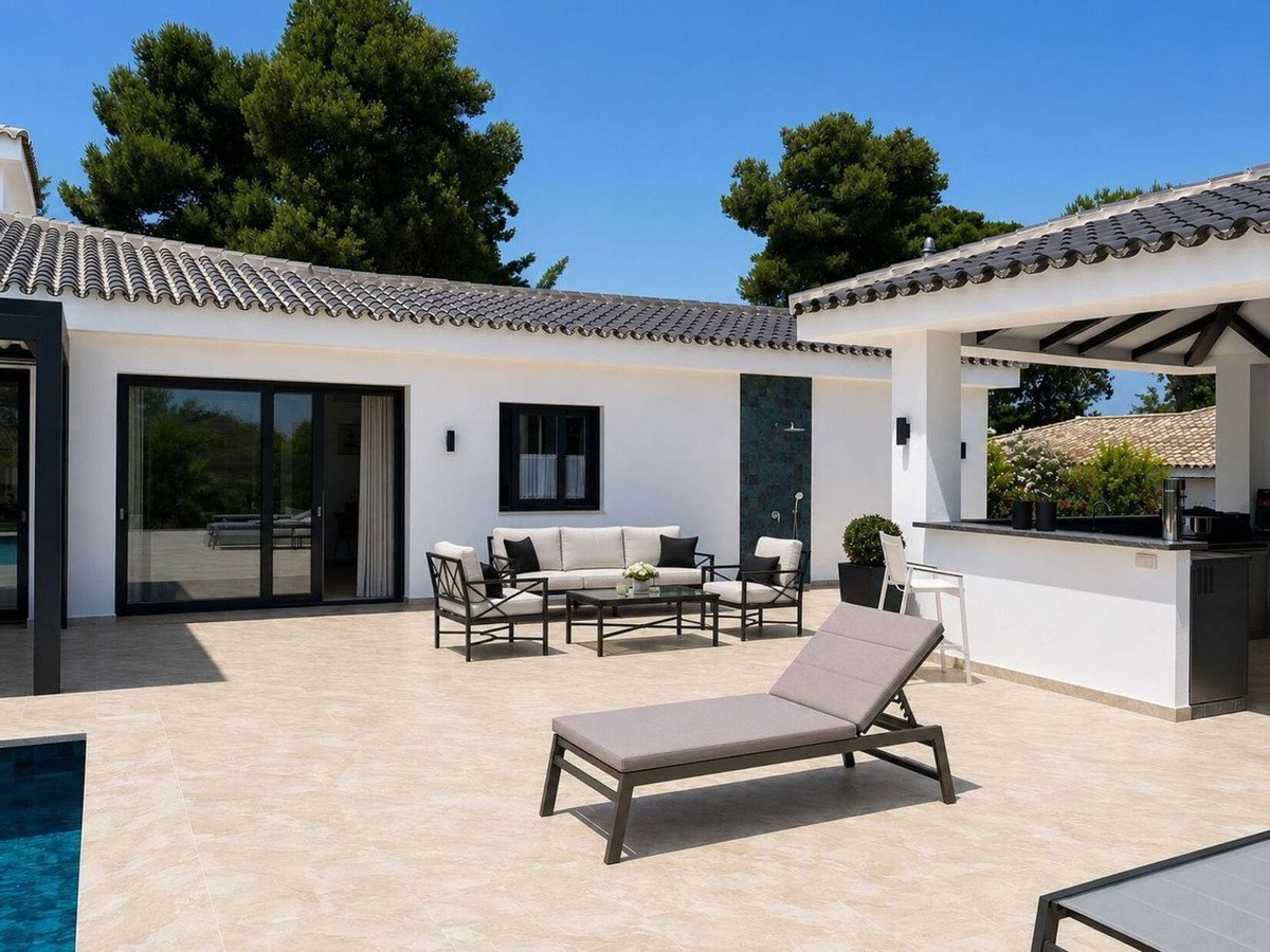 Spacious outdoor patio with lounge seating, a bar, and a pool, perfect for relaxation and entertaining.