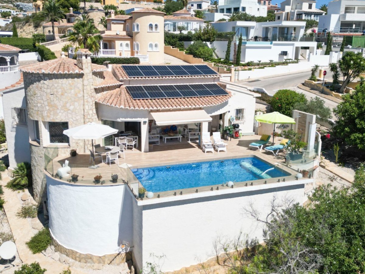 Luxury villa with a swimming pool, terrace, outdoor dining area, and stunning views, perfect for relaxation.