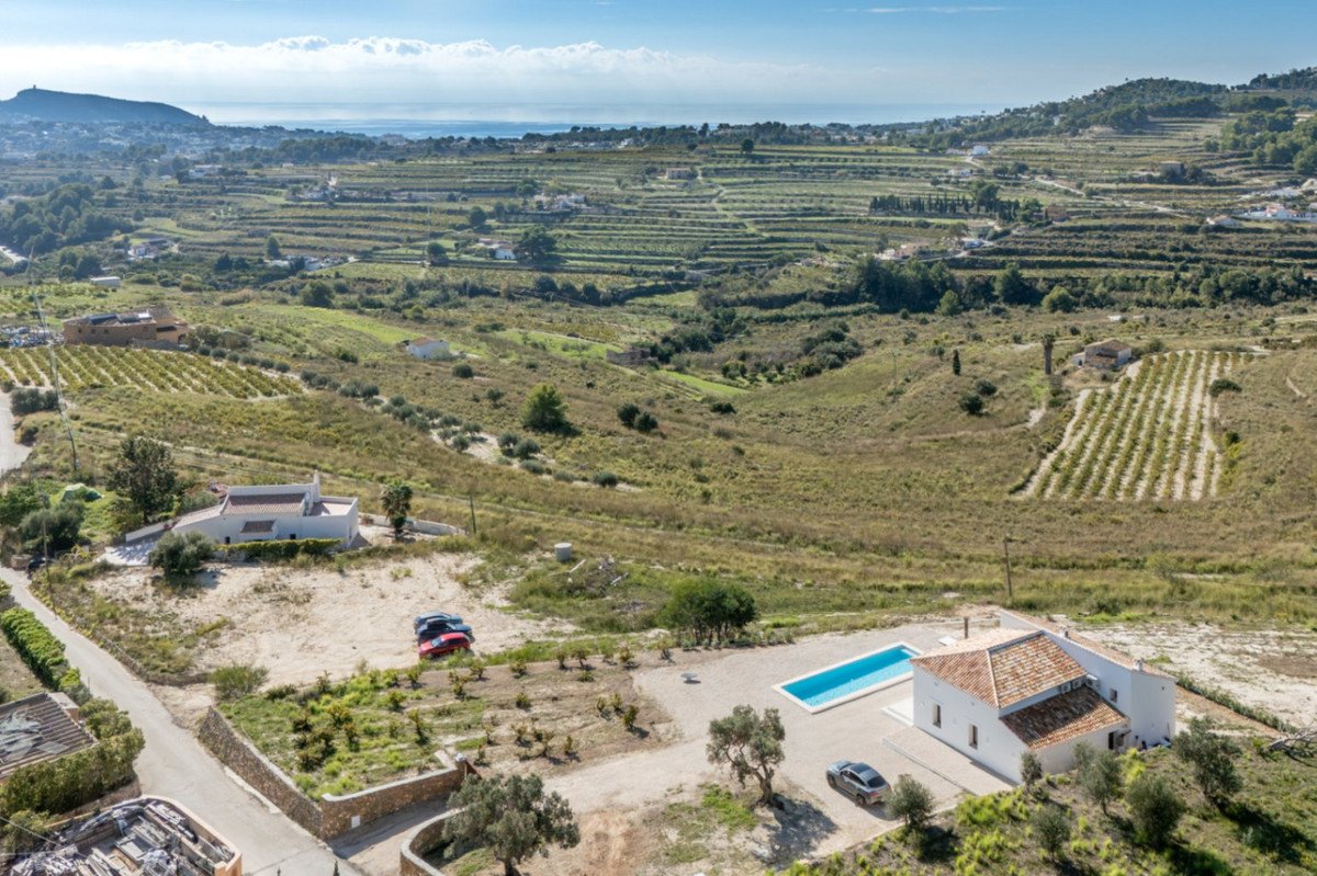 Aerial view of a country house with pool and terraced landscape