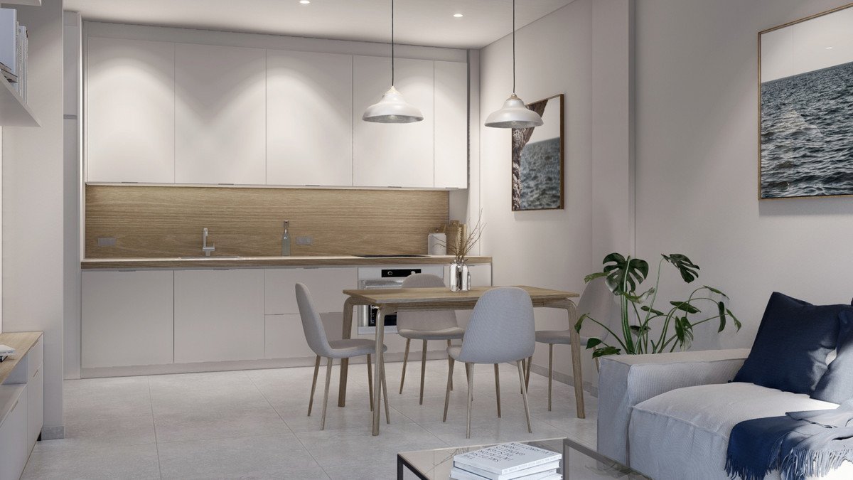 Modern open-plan kitchen and living room with a dining table, chairs, and a sofa.
