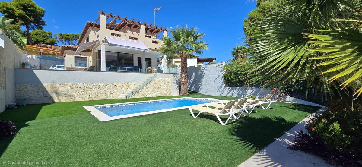 A modern villa with a swimming pool, lounge chairs, and a lush green lawn, under a clear blue sky.