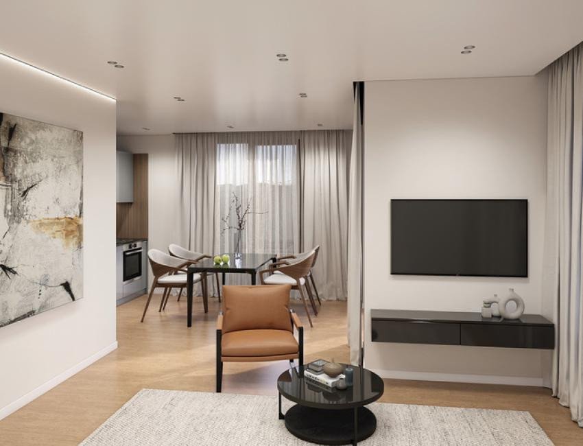 Modern living area with TV and floating cabinet, adjacent to a dining area and a contemporary kitchen.