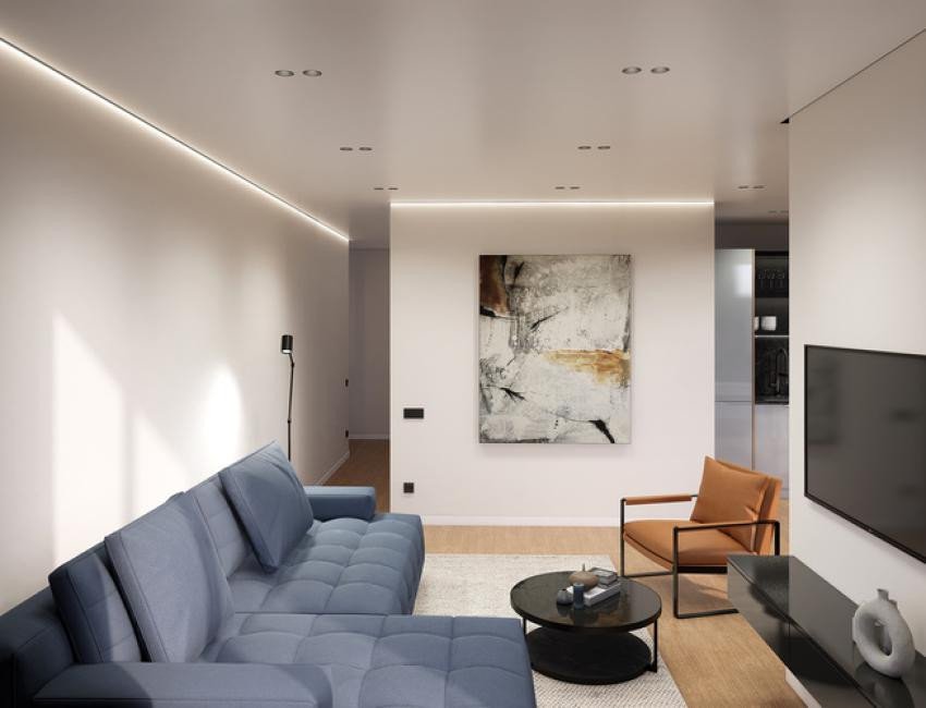 Modern living room with a blue sectional sofa, abstract art, and an accent chair.