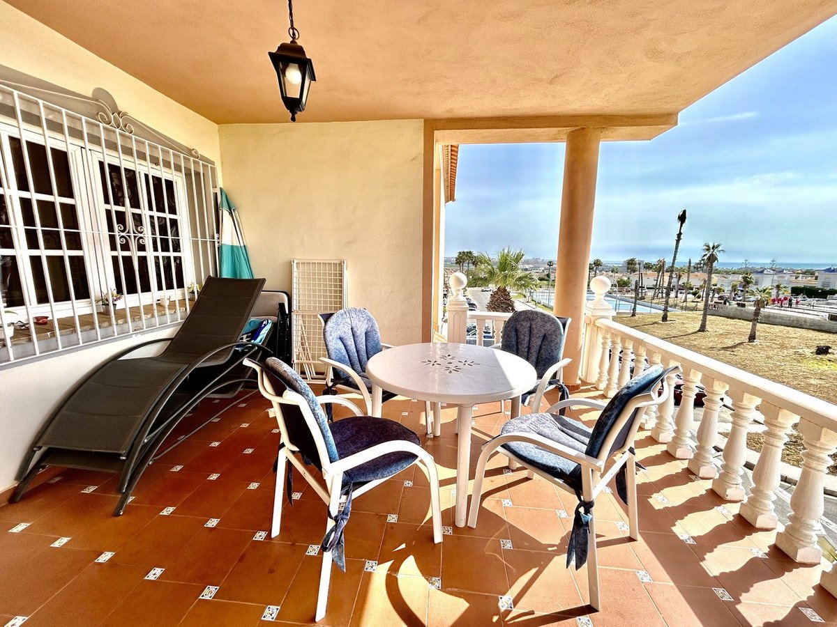 Balcony with table, chairs, and scenic ocean view