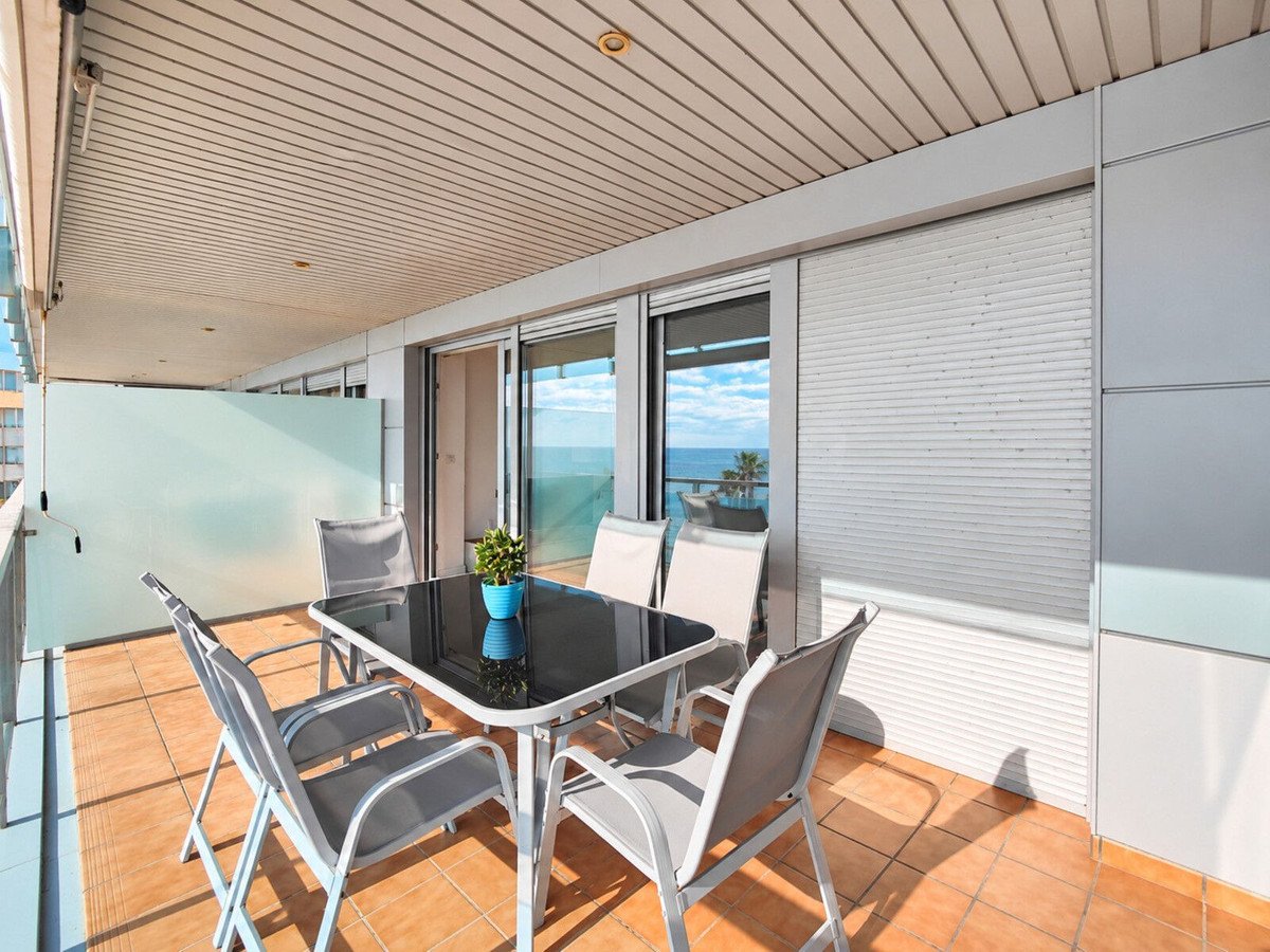 Balcony with dining set overlooking the sea