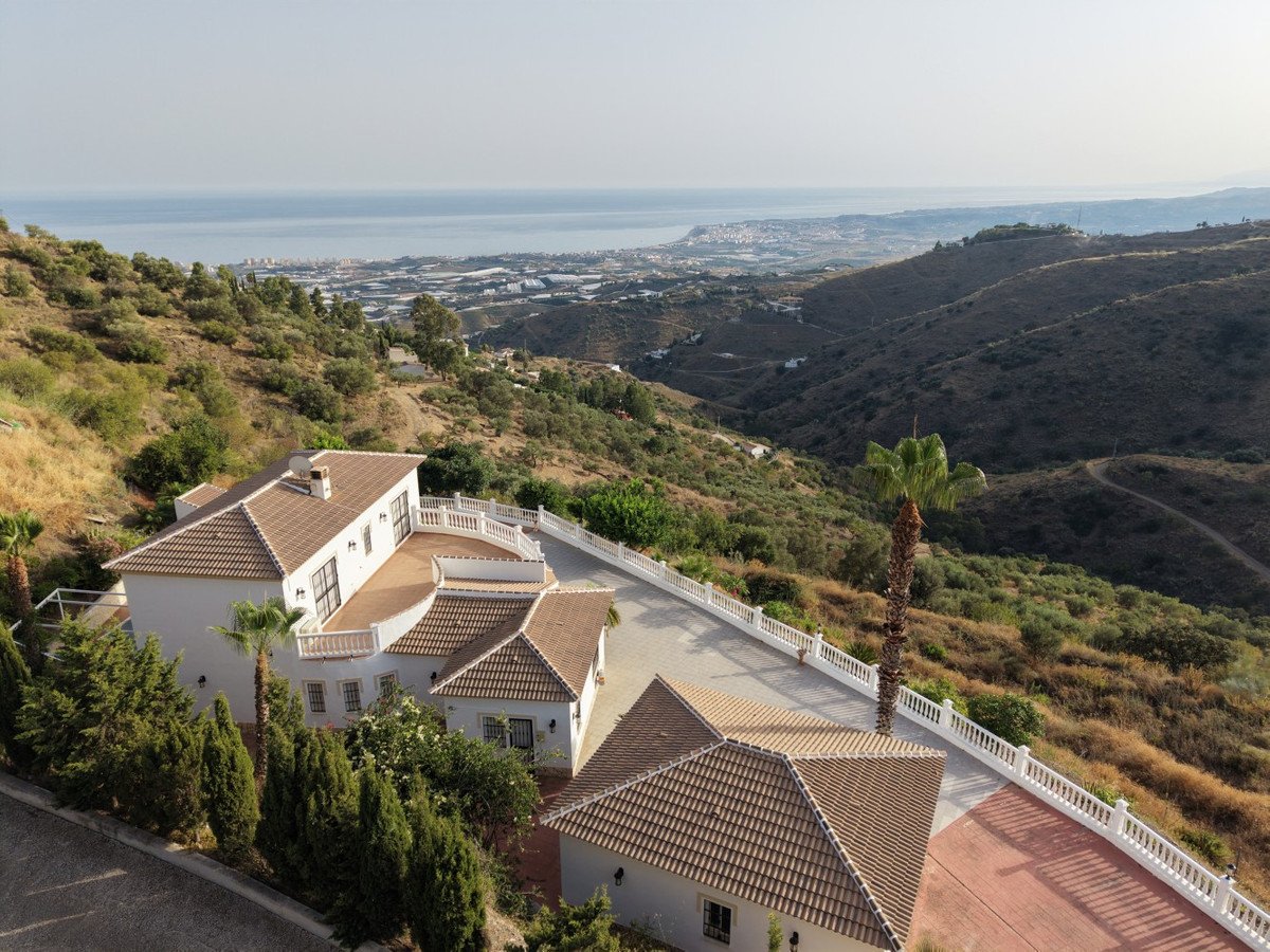 Coastal luxury home with terracotta roofs overlooking the sea