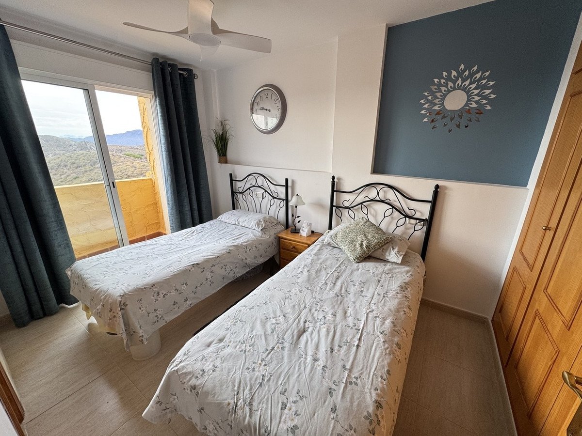 Twin bedroom with two beds, mountain view through sliding doors