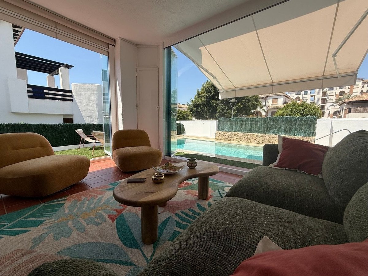 Living room with pool view, modern furniture, and large windows